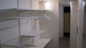 A room with white shelving units, a mirror, and a door leading to another room. - Appartement in Steinhude mit Terrasse und Garten by Interhome (Wunstorf)