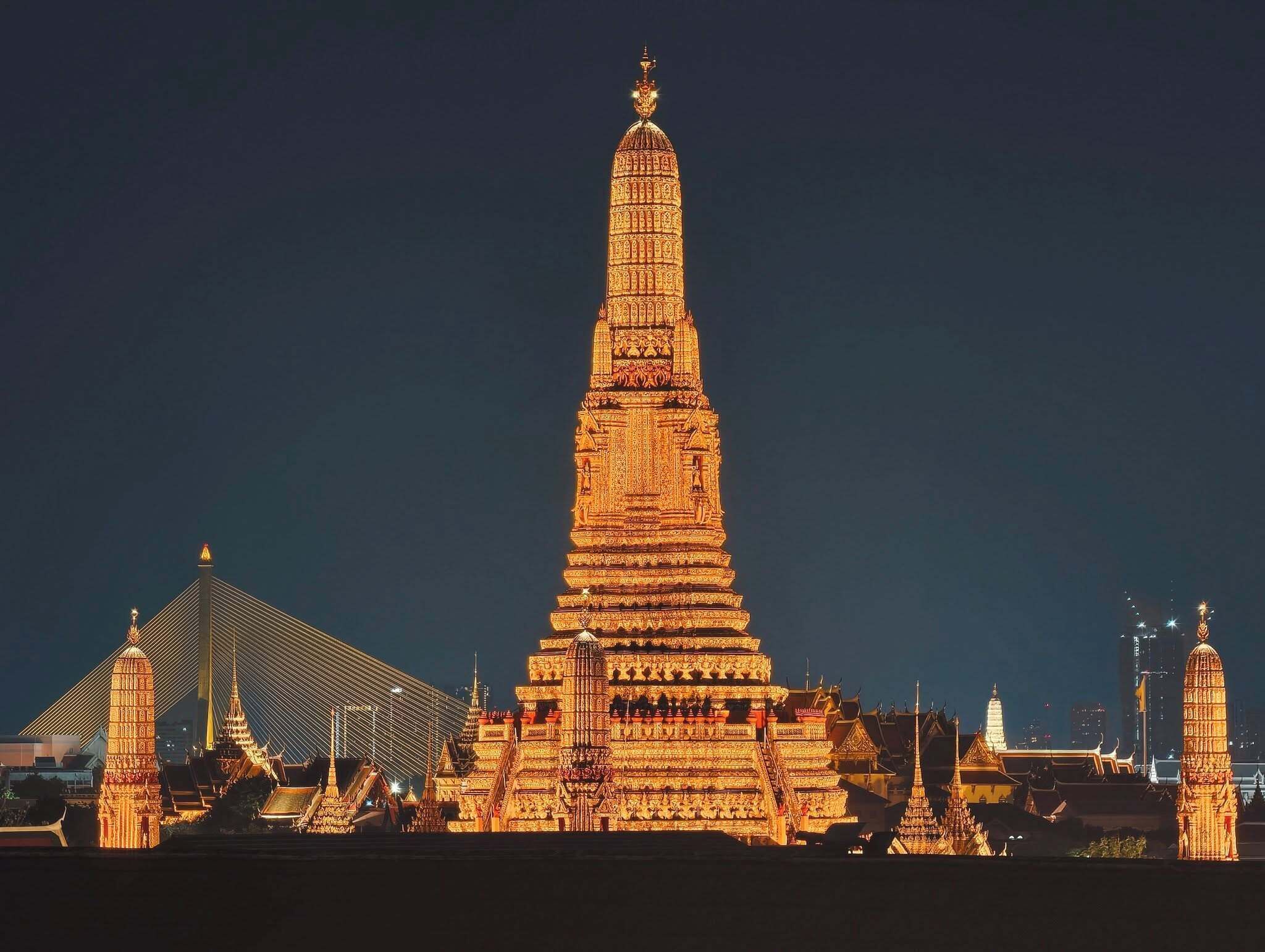 A large, intricately designed temple with multiple tiers and a pointed spire, surrounded by smaller structures.