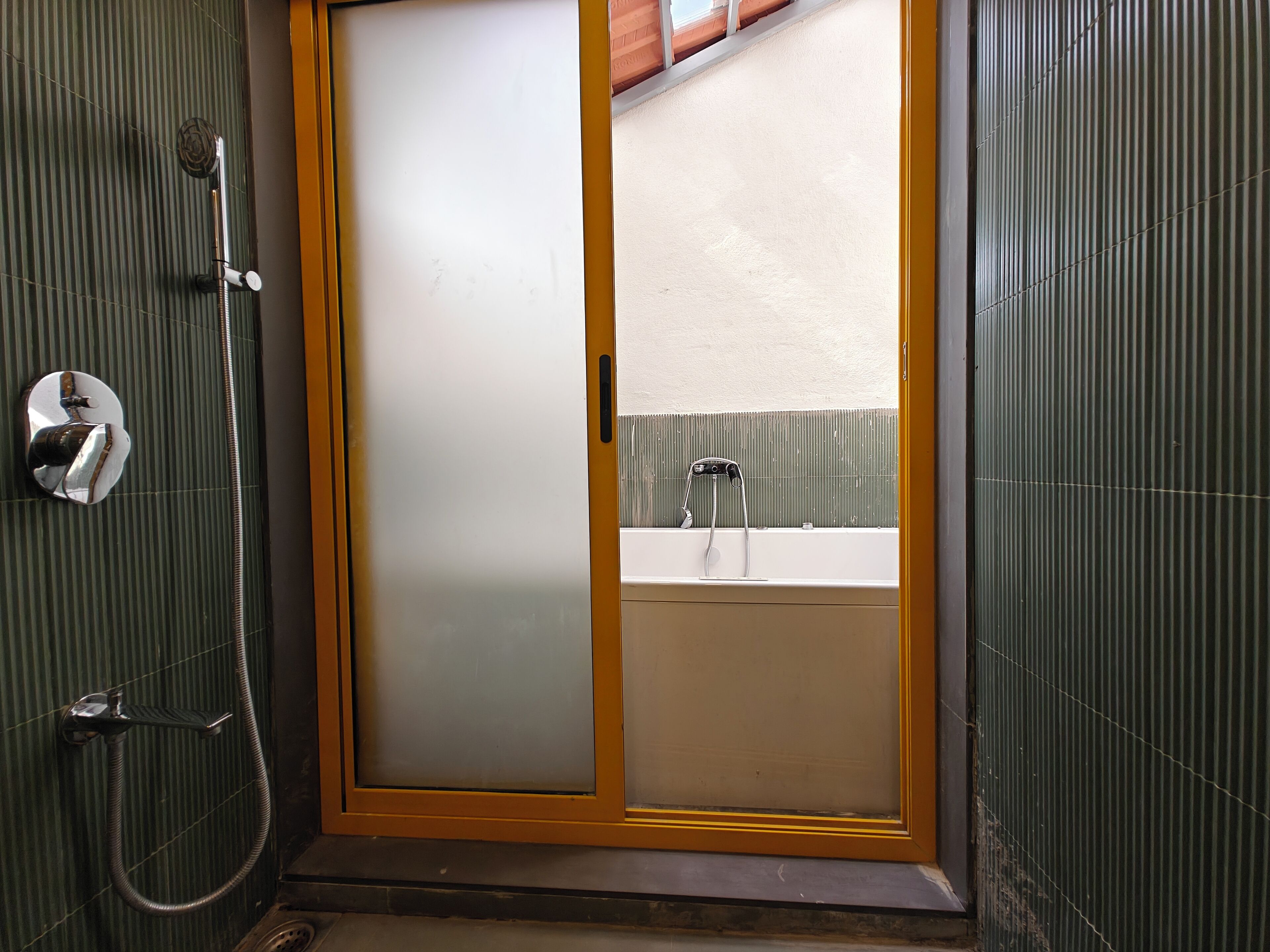 A bathroom with a shower, a toilet, and a sink.