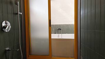 A bathroom with a shower, a toilet, and a sink.