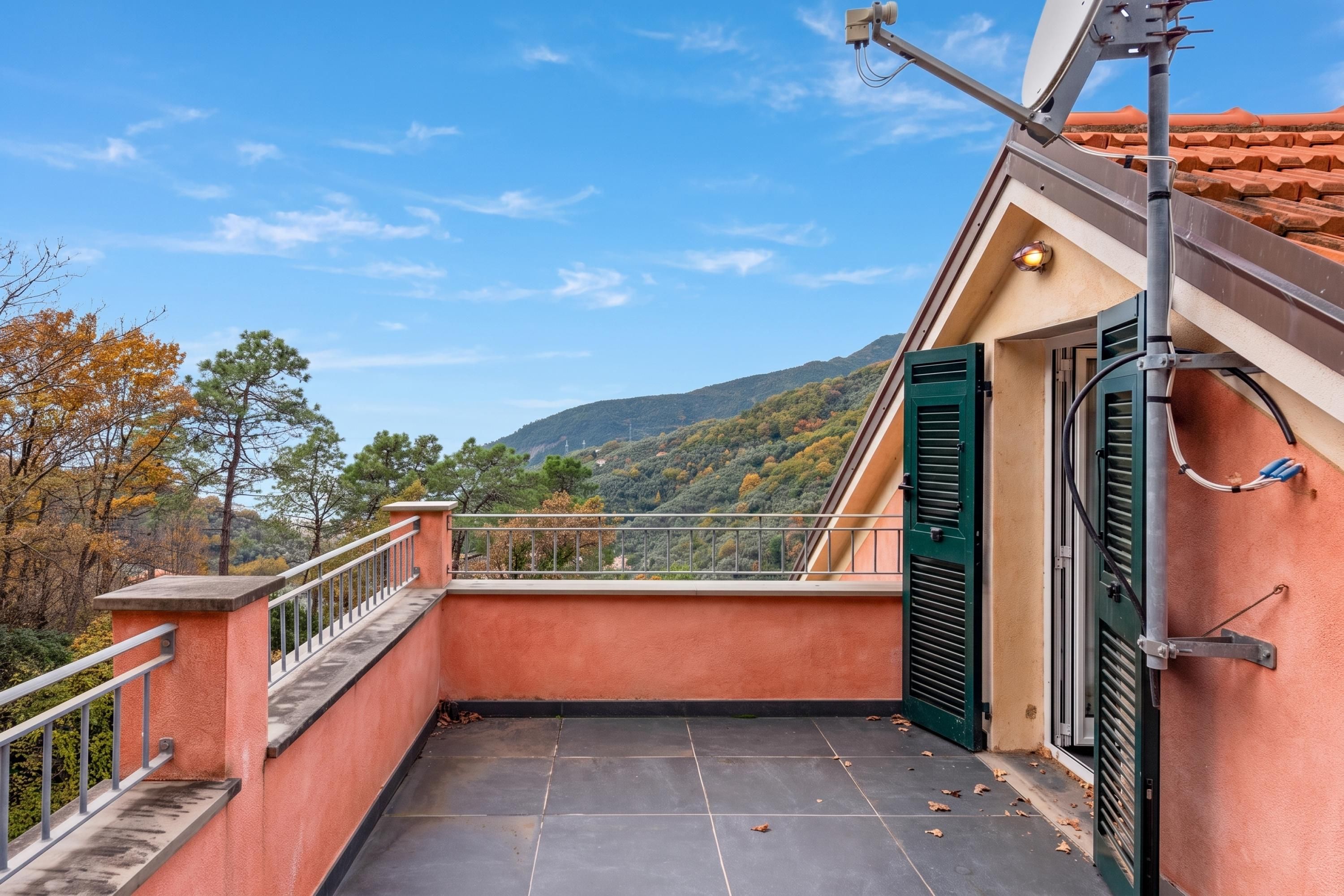A balcony with a view of a mountainous landscape.