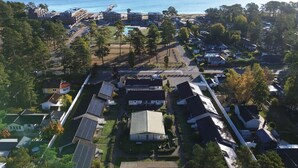 An aerial view of a residential area with houses, a pier, and a beach. - Åhus Havsvillor (Aahus)