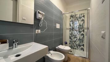Superior Quadruple Room | Bathroom | Shower, hair dryer, towels, soap