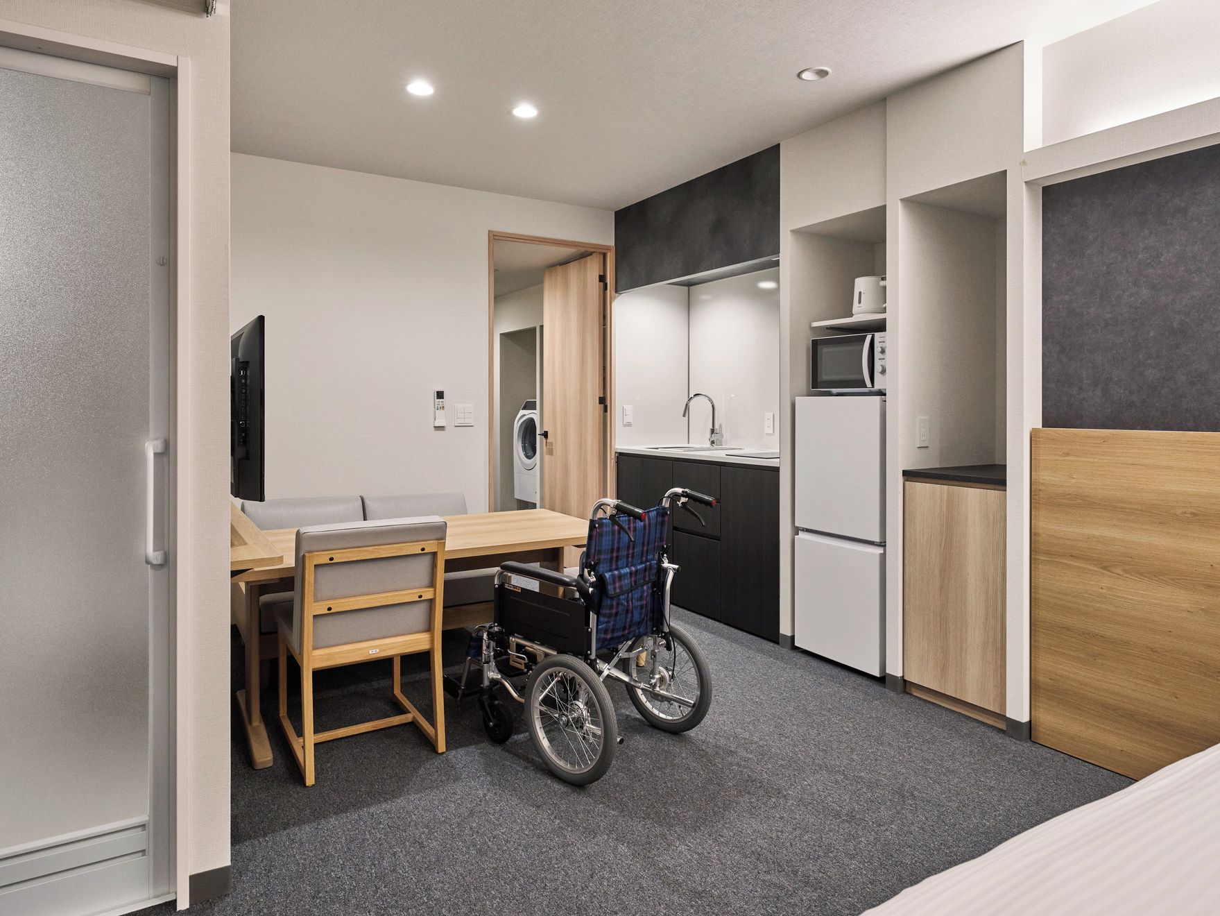 A compact kitchenette with a microwave, sink, and refrigerator.