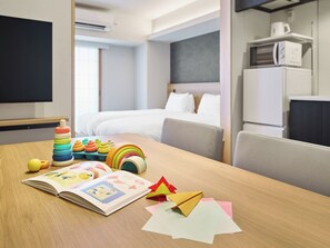 A hotel room with a wooden table, a bed, a TV, and a kitchenette. - MIMARU Osaka Namba Station Annex (Opens on October 1, 2026) (Osaka)