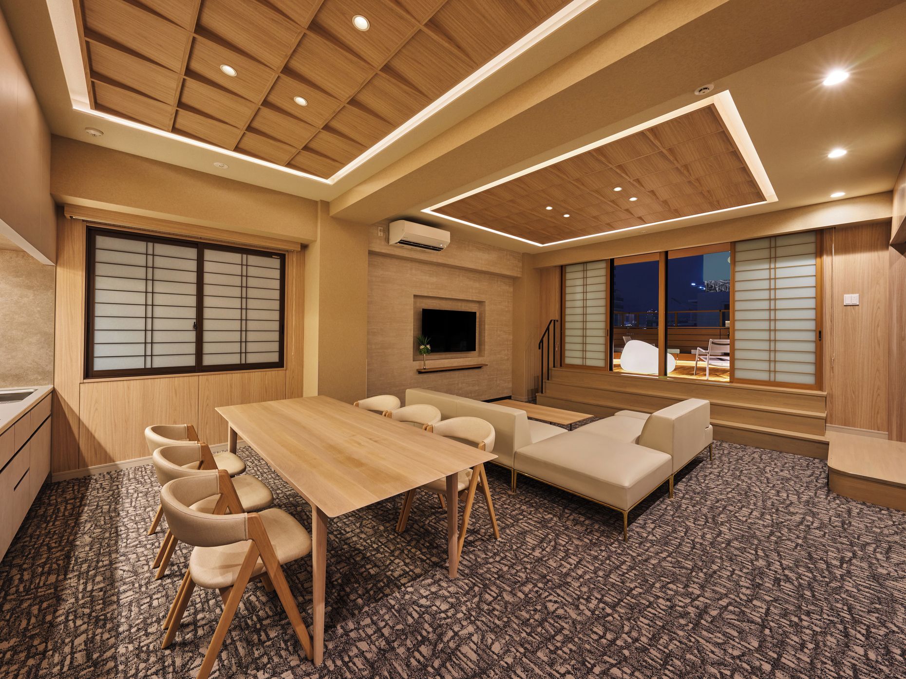 A modern interior with a dining area, sofa, and TV.
