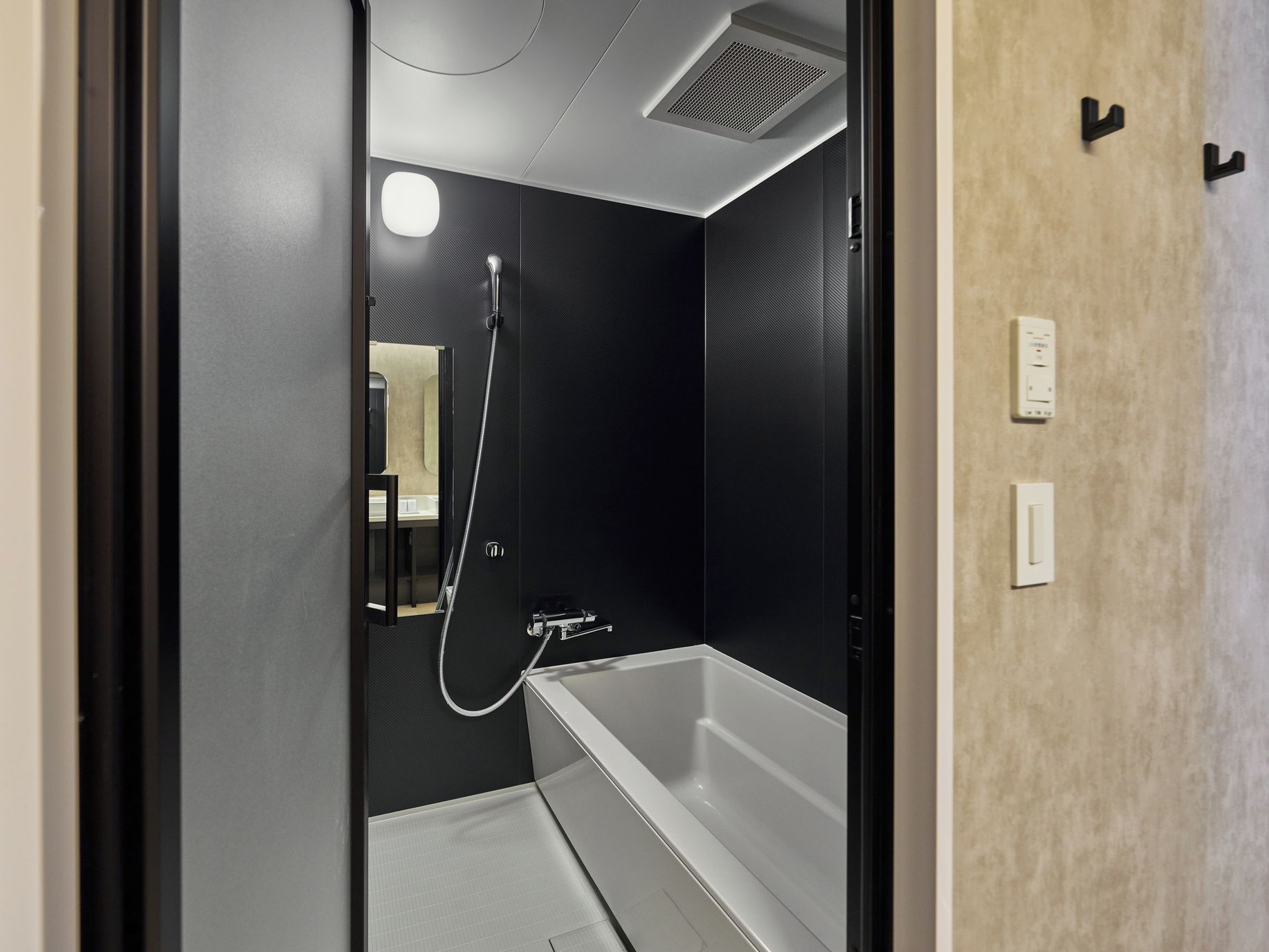 A modern bathroom with a bathtub, a shower, and a toilet.