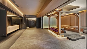 A modern interior with a reception desk, seating area, and a hallway. - MIMARU Osaka Namba Station Annex (Opens on October 1, 2026) (Osaka)