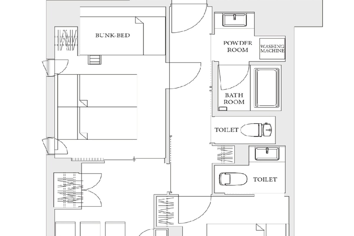 Plattegrond met een stapelbed, gasttoilet, wasmachine, twee badkamers, twee toiletten, een keuken en een woonruimte.
