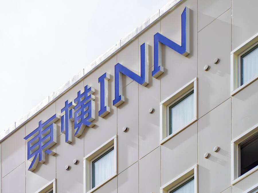 A building with a sign that reads 'INN' in large blue letters.