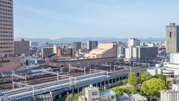 A cityscape with a prominent train station and multiple high-rise buildings.