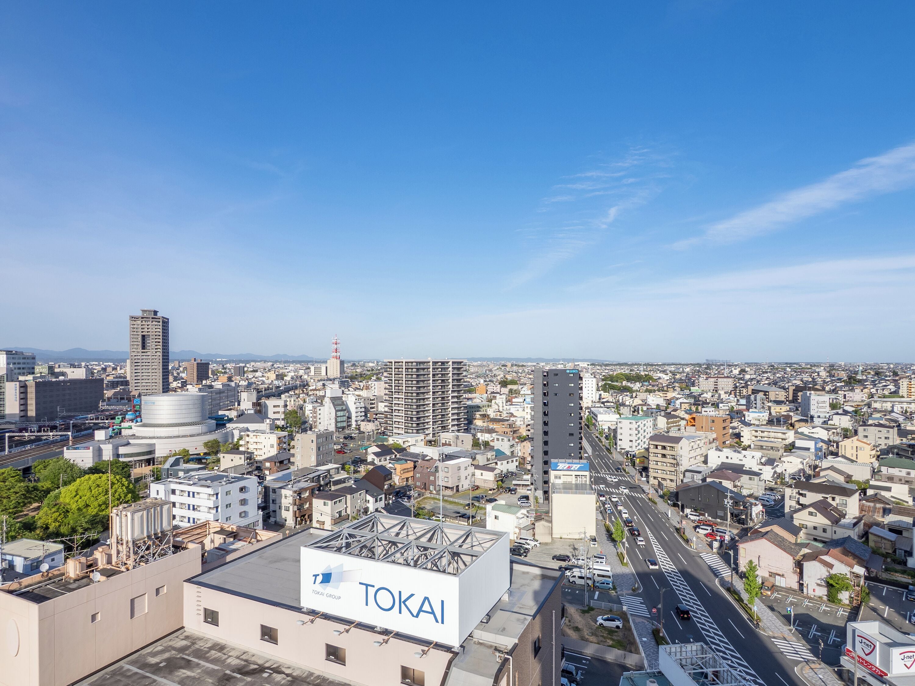 A cityscape with a prominent TOKAI building.