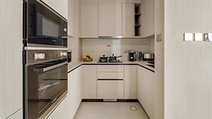 A compact kitchen with a Bosch microwave, double oven, and a coffee maker. - Pearl House II - 1104 1BD (Dubai)