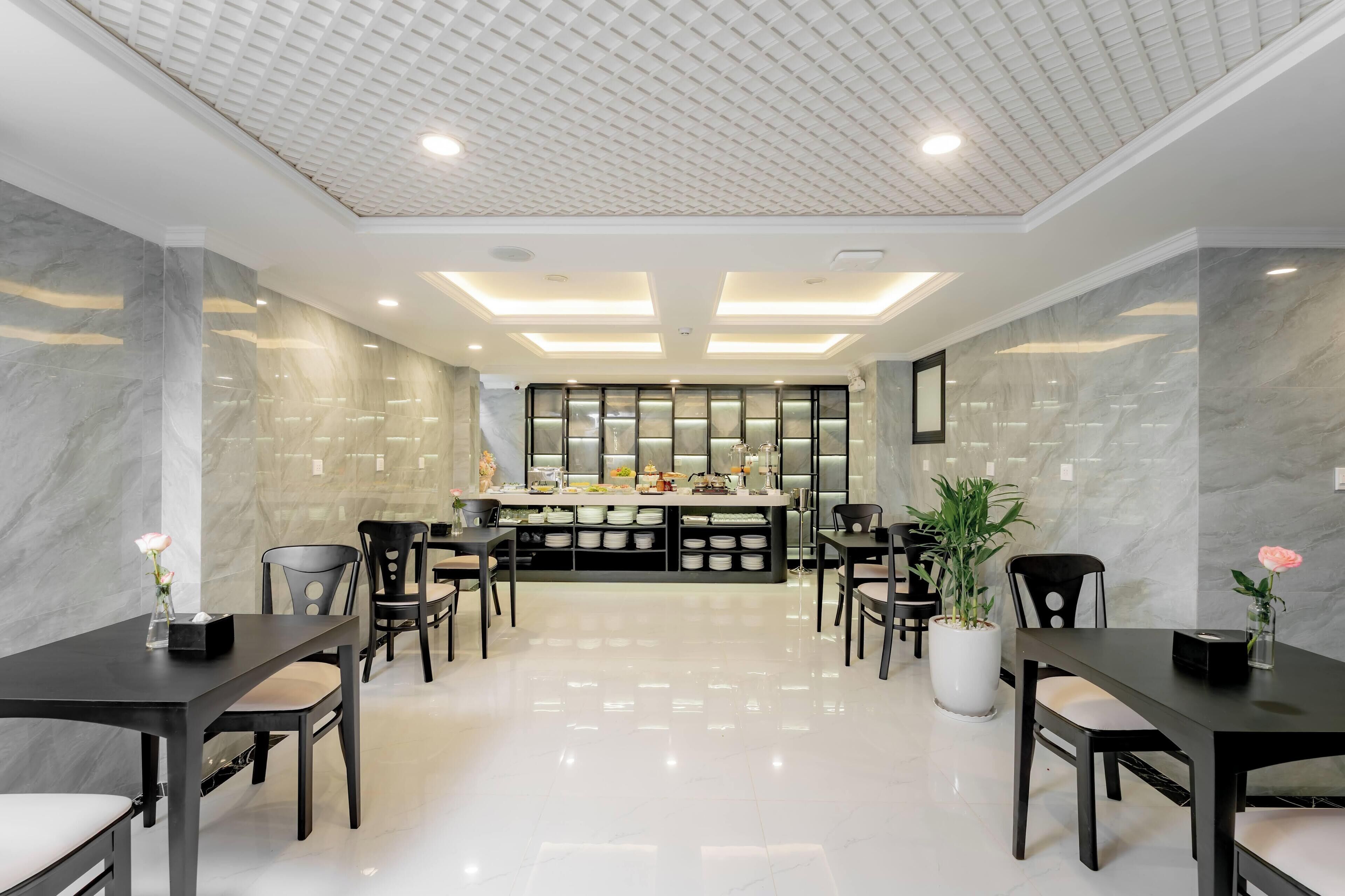 A modern hotel lobby with a central bar area, marble walls, and a polished floor.
