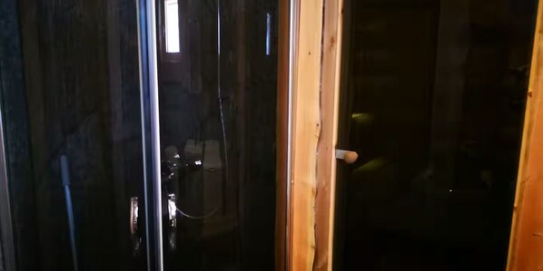 A partially open door with a wooden frame and a metal handle.