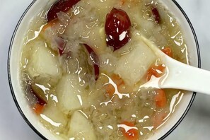 A bowl of soup with a white spoon. - Jintai Hotel (Wuhan)
