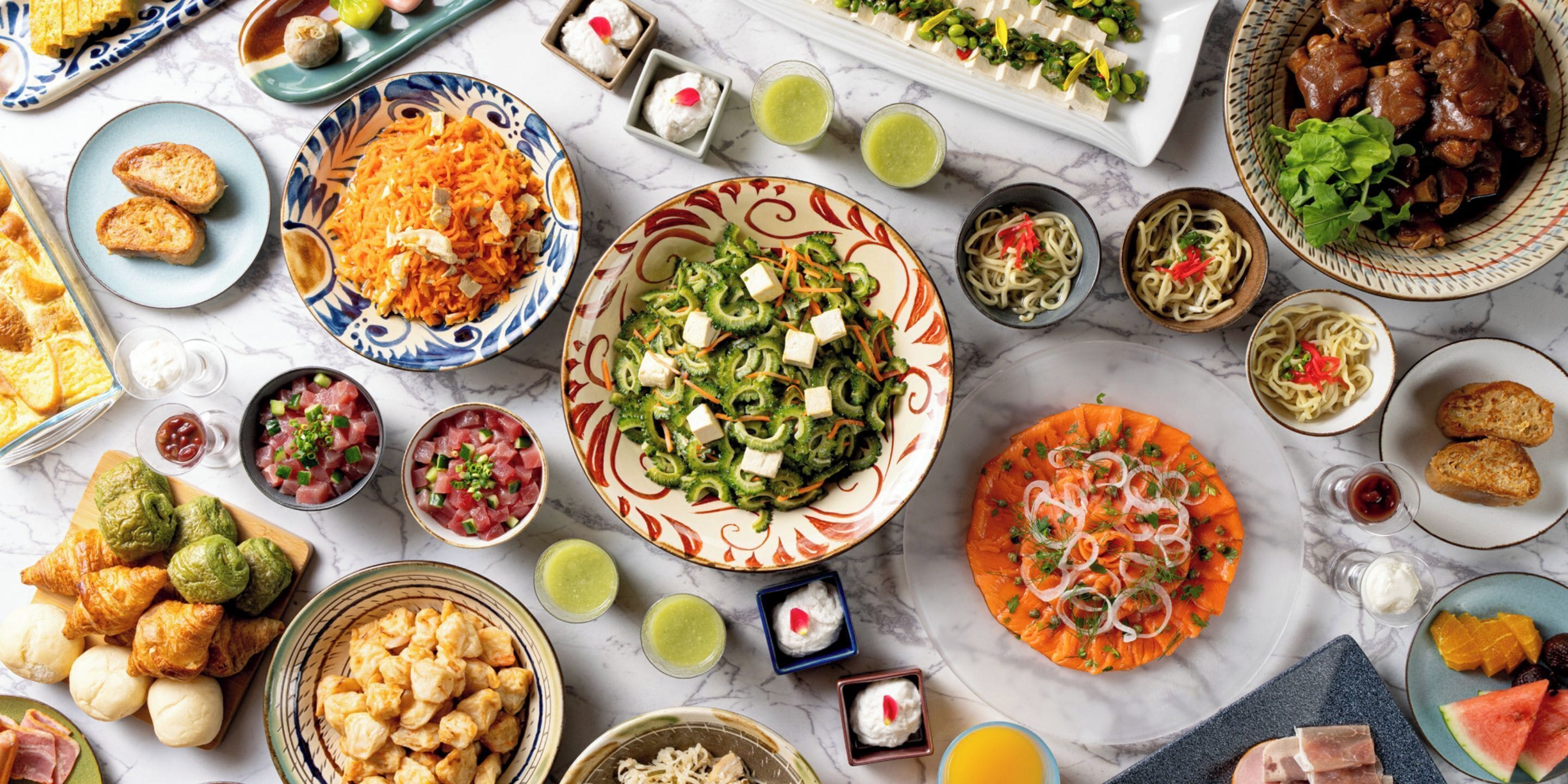 A variety of dishes on a marble table.