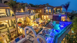 A luxurious resort with multiple swimming pools, outdoor seating areas, and a well-lit patio. - Dali Sea Coconut Muxin Yeelen Villa (Dali)