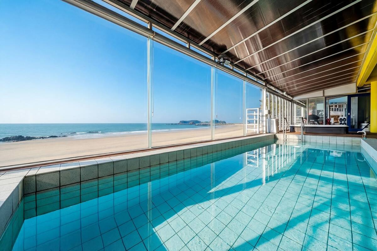 Una piscina con vistas a la playa y al océano.