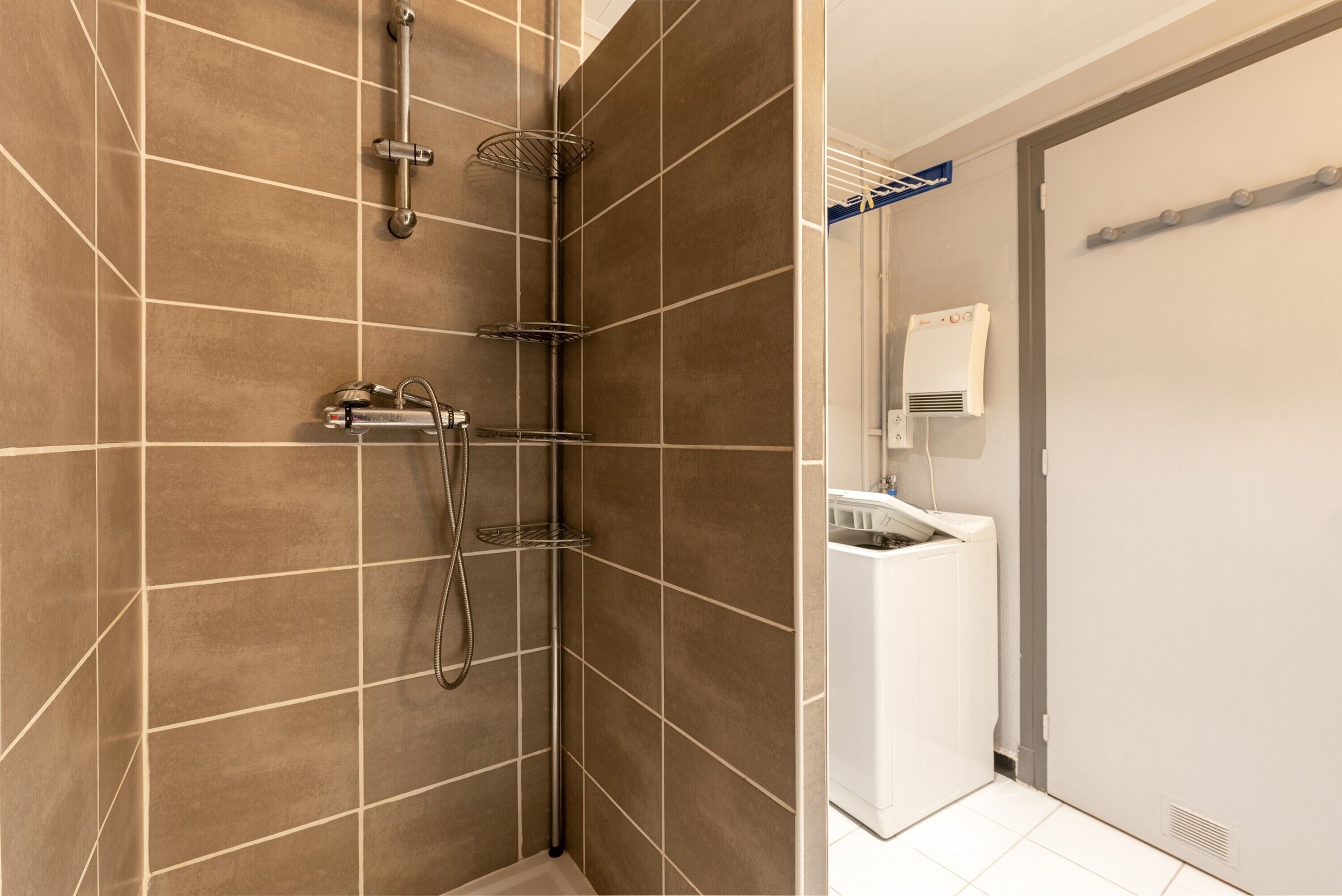 A modern bathroom with a shower, a toilet, and a sink.