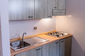 Comfort Duplex | Private kitchen | Full-size fridge, cookware/dishes/utensils, dining tables