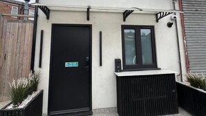 A modern building with a black door, a small window, and a sign that reads "Paragraph." - Paragraph Tottenham (London)