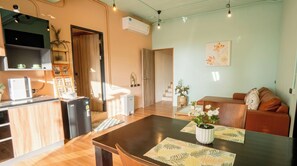 A modern living space with a kitchen, dining area, and seating area. - Jaokhun Hilltop Patong Phuket (Patong)