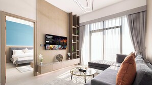 A modern hotel room with a bed, a sofa, a coffee table, and a TV mounted on the wall. - Spacious 1BR with Modern Amenities in Westwood Grande, JVC (Jumeirah Village Circle)