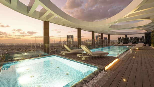 A rooftop infinity pool with lounge chairs, a city view, and a modern architectural design. - Spacious 1BR with Modern Amenities in Westwood Grande, JVC (Jumeirah Village Circle)