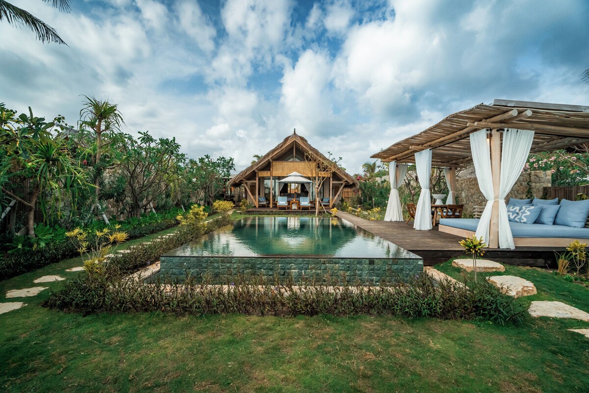 A resort with a pool, wooden deck, and outdoor seating area.