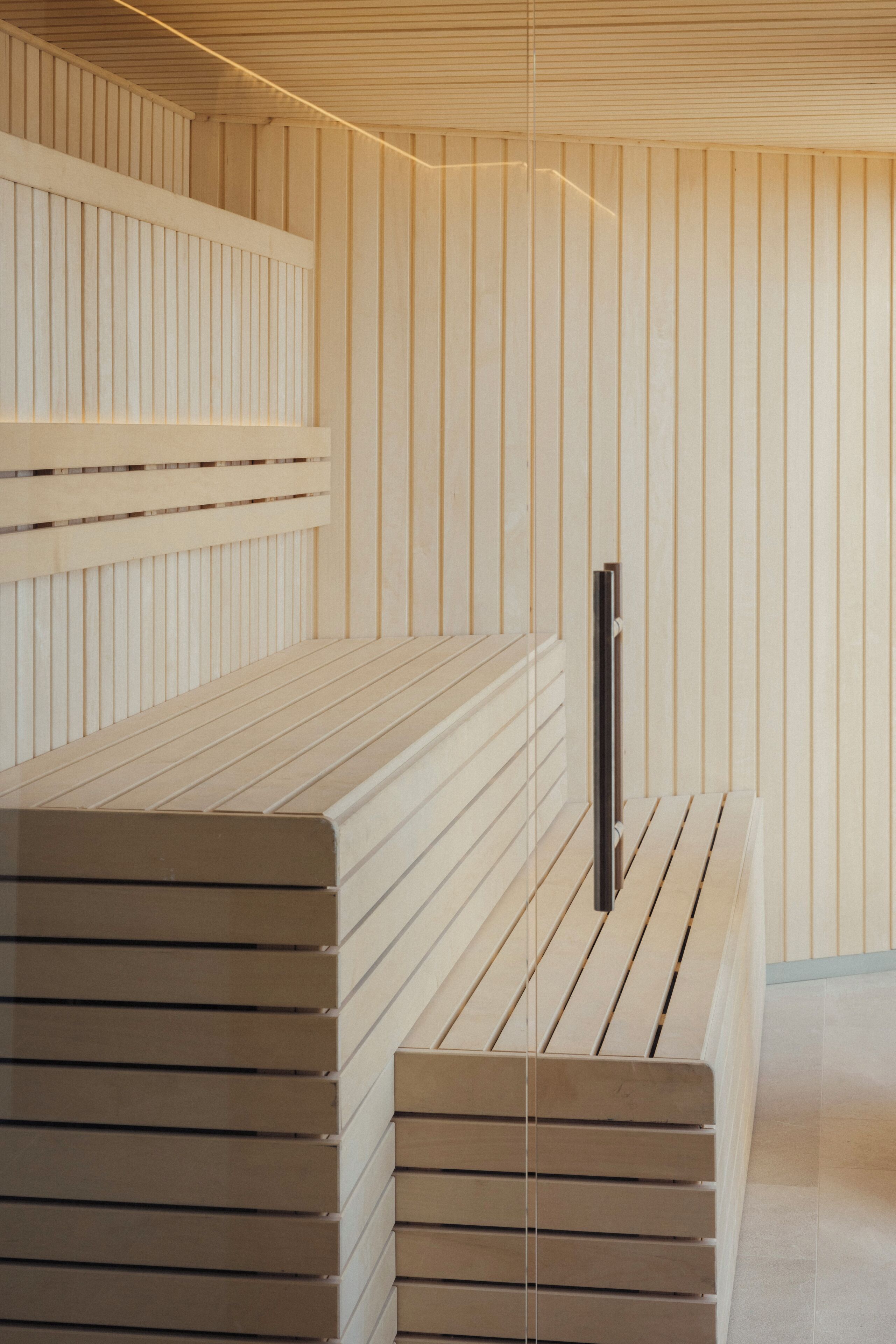 A modern interior with wooden slatted benches and a minimalist design.