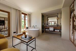 A modern bathroom with a freestanding bathtub, a vanity with a mirror, and a large window with curtains. - Gran Hotel Margalida Mallorca by Annua Signature - New Opening (Banyalbufar)
