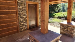 A wooden exterior with a stone door and a stone fireplace. - Tranquil 1-bedroom apartment in Donnelly perfect for a getaway (Donnelly)