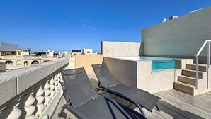 A rooftop terrace with a pool, lounge chairs, and a staircase leading to an upper level. - Rooftop Villa w/ Pvt Plunge Pool & BBQ in South (Ħal Għaxaq)