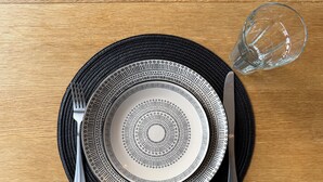 A table set with a black and white patterned plate, a fork, a knife, and a glass. - Modern 3-Bedroom Home in Bletchley, Milton Keynes (Bletchley)