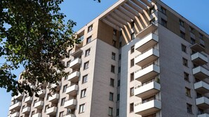 A multi-story residential building with balconies, a pedestrian walkway, and a parking area. - Quiet and well decorated apartment, city heart, Świętokrzyska (Kraków)