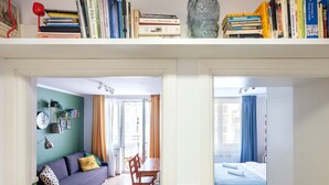 A split-view of a room with a sofa, dining table, and a bed. - Quiet and well decorated apartment, city heart, Świętokrzyska (Kraków)