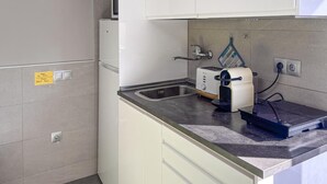 A kitchen with a sink, a toaster, and a coffee maker. - Awesome apartment in Benalmadena (Benalmadena)