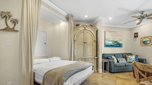 A bedroom with a bed, a wardrobe, a sofa, and a ceiling fan. - 1 bed Beach Pools Waterfront Boating Palmaway (Orange Beach)