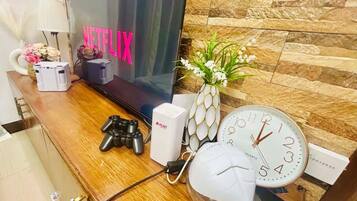 Comfort Condo, 1 Bedroom, Balcony, City View | Living room | 32-inch Smart TV with digital channels, Netflix, books