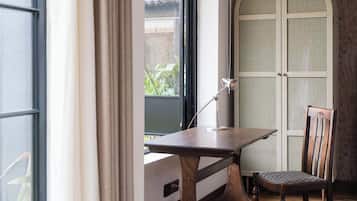 Desk, laptop workspace, blackout drapes, iron/ironing board