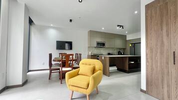 Superior Apartment, City View | Living area | Flat-screen TV