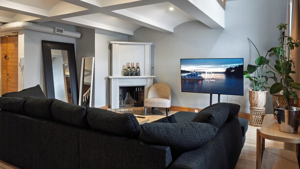 A modern living room with a large sectional sofa, a flat-screen TV, and a fireplace. - Seafront lounge in the centre of Helsinki, Ideal for party and corporate events. (Helsinki)