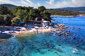 A coastal area with a beach, clear water, and a small building with a roof. - Villa Ancora - Merope Apt /w Jacuzzi & Terrace (Mali Losinj)