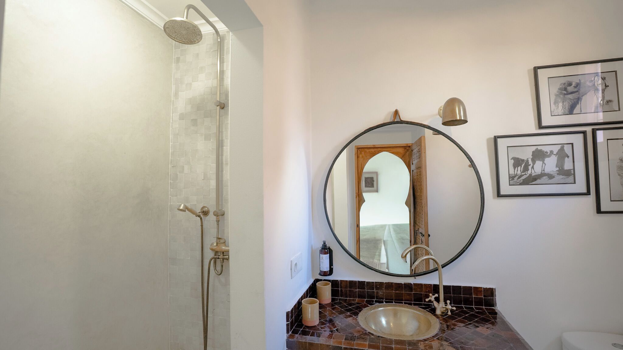 A bathroom with a shower, a sink, and a mirror.