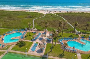 A resort with two swimming pools, sun loungers, and a beach view. - Sleeps 10 Direct Beach Heated Pool 3 Bedroom Apts (South Padre Island)