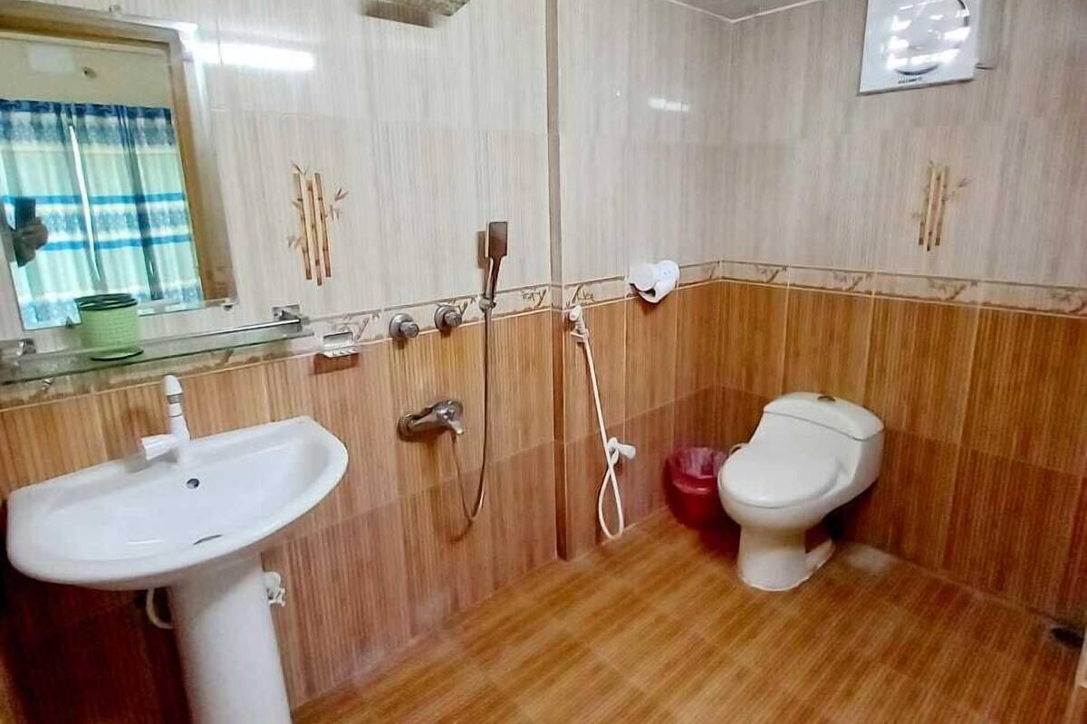 A bathroom with a sink, toilet, and shower.