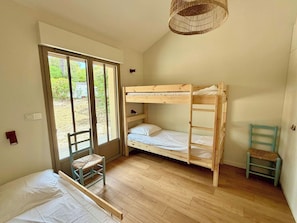 A room with a bunk bed, a chair, and a hanging light fixture. - Comfortable penthouse, spacious terrace A0383 (Lège-Cap-Ferret)