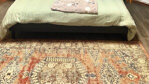 A spacious room with a large bed, a wooden ceiling, and a decorative wall hanging. - Boho Yurt Stay ~ Cozy & Unique ~ Massage Chair (Athens)