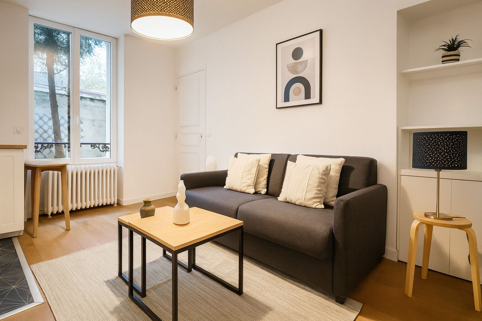A modern living room with a sofa, a small table, a floor lamp, and a radiator.